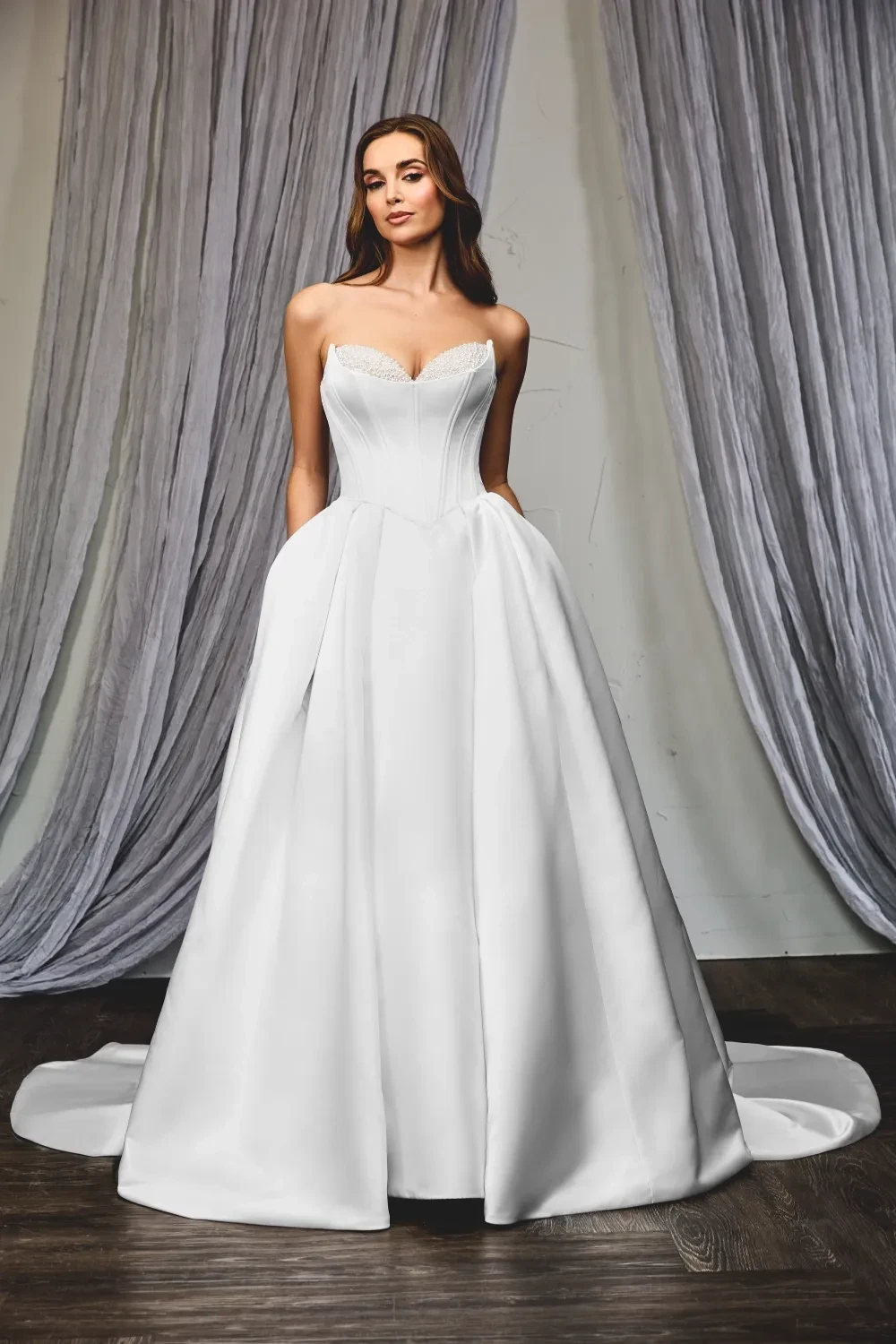 Model wearing a Sarah J Bridal white gown